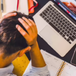 man stressed out working on laptop