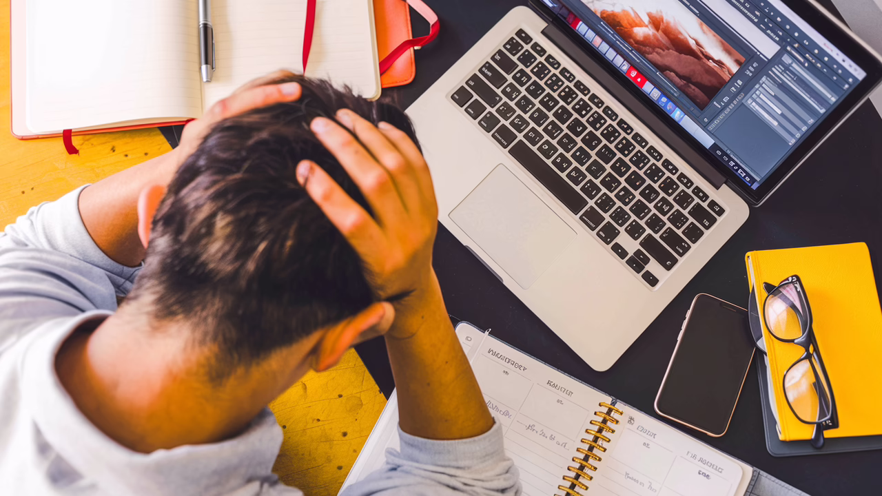 man stressed out working on laptop